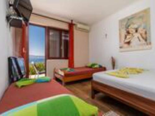 a bedroom with two beds and a view of the ocean at Apartments Roma - One Bedroom Apartment in Celina