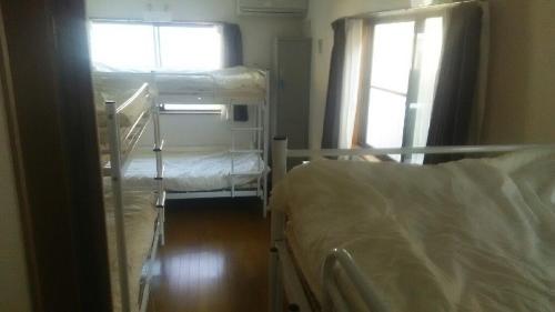 Postel nebo postele na pokoji v ubytování J's Backpackers