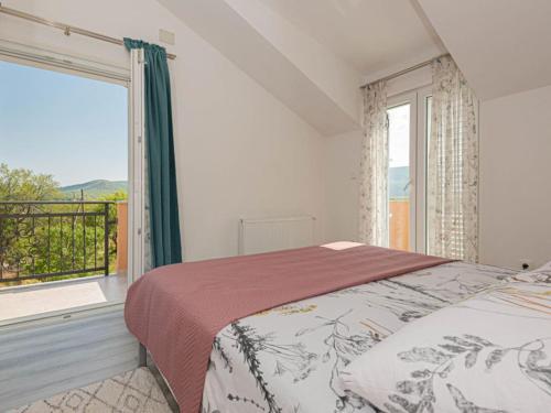 a bedroom with a bed and a large window at Villa Maria with Outdoor Pool - Five Bedroom Villa with Outdoor Pool in Otavice