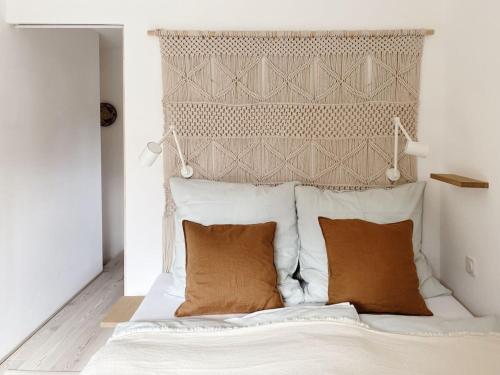 a white bed with two pillows and a headboard at Holiday apartment with 2 bedrooms in Oberammergau