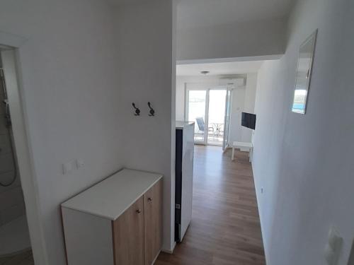 a white room with a kitchen and a hallway at One-Bedroom Apartment A1 in Stošići