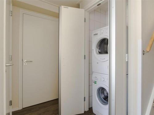 a laundry room with a washer and dryer at Holiday home in Nes with swimming pool in Nes