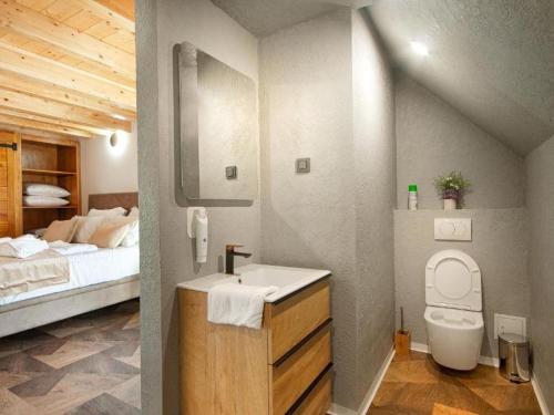 a bathroom with a sink and a bed in a room at Family Resort Plitvice Lakes- Mountain view Petar in Rastovača