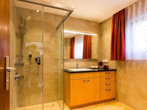a bathroom with a shower and a sink at Holiday home with 3 bedrooms in Frutenhof