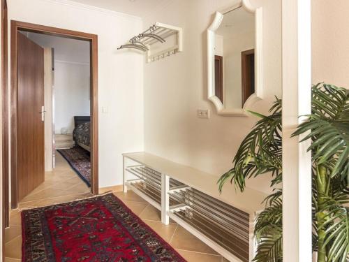 a hallway with a door and a mirror and a rug at Holiday home with 3 bedrooms in Frutenhof