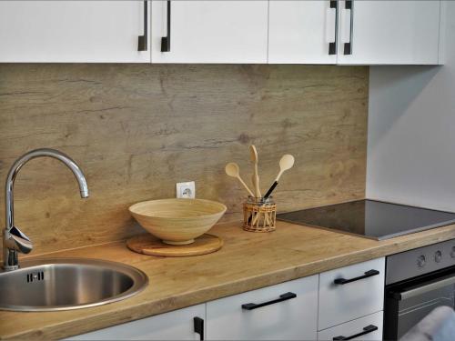 a kitchen with a sink and a bowl on a counter at Tranquil Luxe Thermal Escape Mobile Home - Premium Mobile Home with Terrace in Mostec