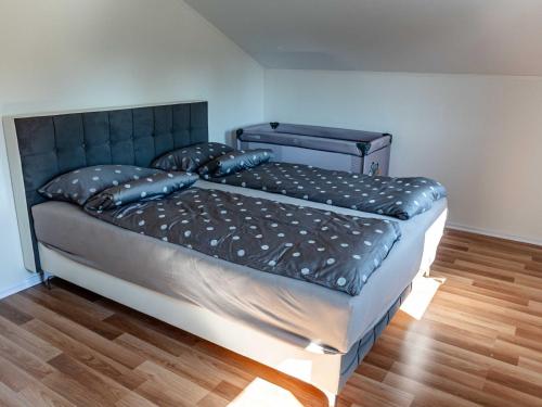 a bedroom with a large bed with a black headboard at Tranquil Luxe Thermal Escape Mobile Home - Premium Mobile Home with Terrace in Mostec