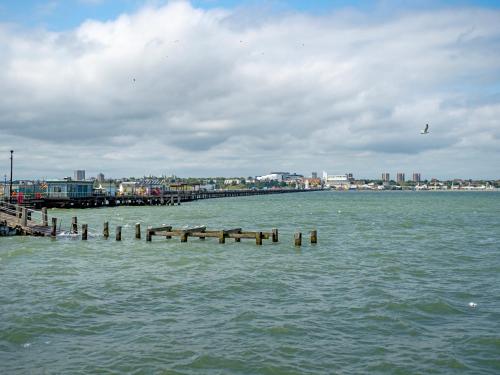 a pier in the water with a city in the background at Orchard House - Uk48580 in Rochford