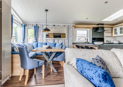 a living room with a couch and a table at Hanworth Country Park in Potter Hanworth