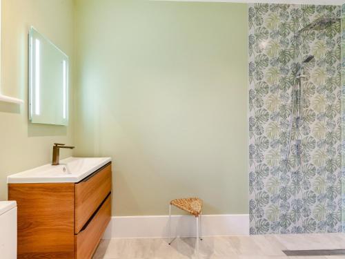 a bathroom with a sink and a shower curtain at The Cartlodge - Uk48579 in Rochford