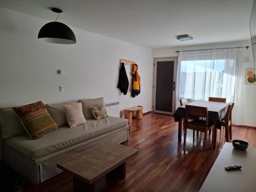 a living room with a couch and a table at Quinta Luna 10 - Playa Bonita in San Carlos de Bariloche