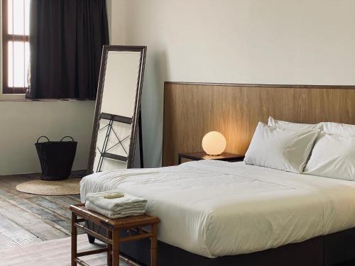 a bedroom with a bed and a mirror and a ladder at Aayu Chowrasta - 3 mins walk to Penang Road Chendul in George Town