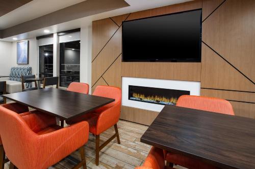 a conference room with a table and chairs and a tv at Holiday Inn Express & Suites Eden Prairie - Minneapolis by IHG in Eden Prairie