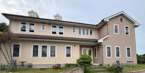 a large house with white windows at Oceanview 16 IKI in Iki