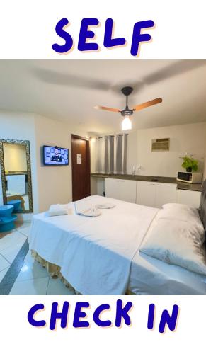a bedroom with a white bed with the words sale check in at VA Apart Hotel Savassi in Divinópolis
