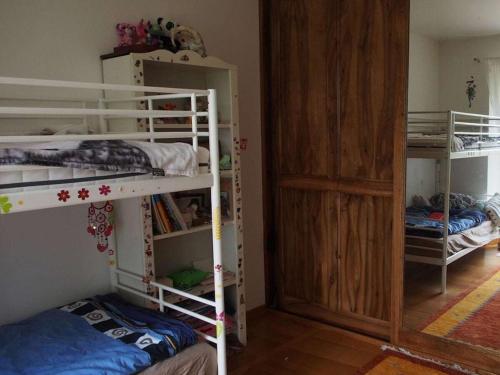 a room with two bunk beds and a door at Pas de Baoussac in Salayrac
