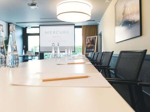a conference room with a long table and chairs at Mercure Metz Centre in Metz