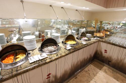 a buffet line with many different types of food at Fiesta Inn Insurgentes Viaducto in Mexico City