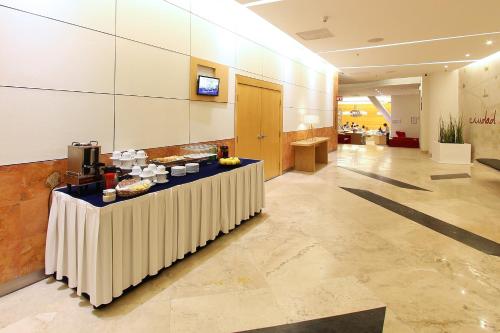 a lobby with a table with food on it at Fiesta Inn Insurgentes Viaducto in Mexico City