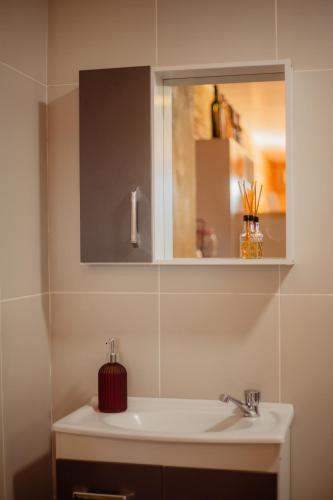 a bathroom with a white sink and a mirror at Refúgio dos Capitéis in Farroupilha