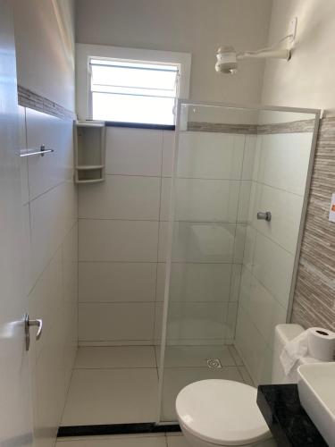 a bathroom with a shower with a toilet and a sink at Atalaia mar in Aracaju
