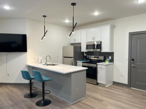 a kitchen with white cabinets and a sink and a counter at Richmond Church Hill North Deluxe Apt 208 in Richmond