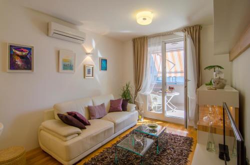 a living room with a couch and a table at Harmony Apartment in Split