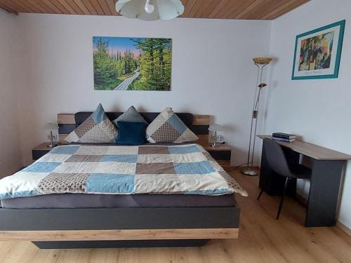 a bedroom with a bed and a desk in it at Holiday home Corinna in Kirchdorf im Wald