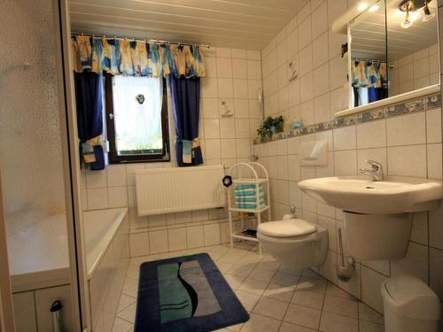 a bathroom with a sink and a toilet and a bath tub at Holiday home Corinna in Kirchdorf im Wald
