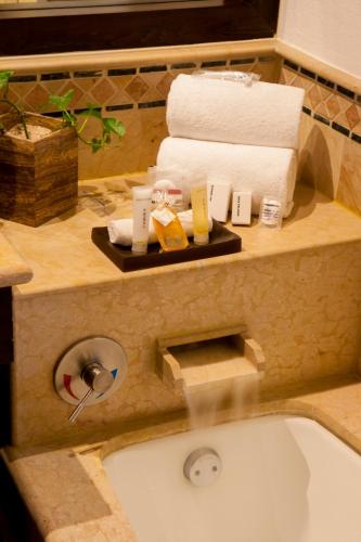 a bathroom with a sink with towels on a counter at Grand Fiesta Americana Los Cabos All Inclusive Golf & Spa in Cabo San Lucas