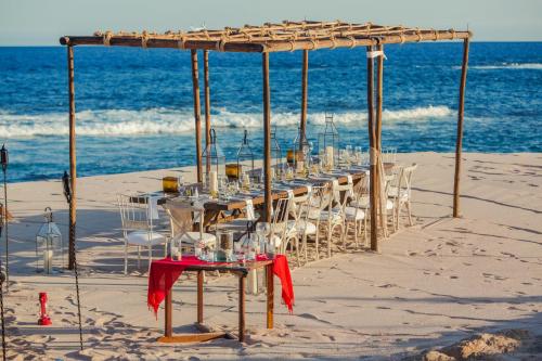 a row of tables and chairs on the beach at Grand Fiesta Americana Los Cabos All Inclusive Golf & Spa in Cabo San Lucas
