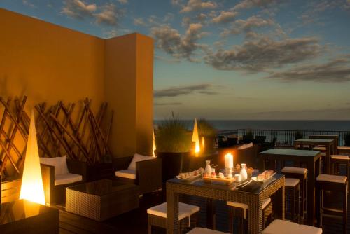 a balcony with chairs and a table with candles at Grand Fiesta Americana Los Cabos All Inclusive Golf & Spa in Cabo San Lucas