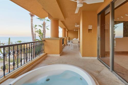 a bath tub on a balcony with a view of the ocean at Grand Fiesta Americana Los Cabos All Inclusive Golf & Spa in Cabo San Lucas