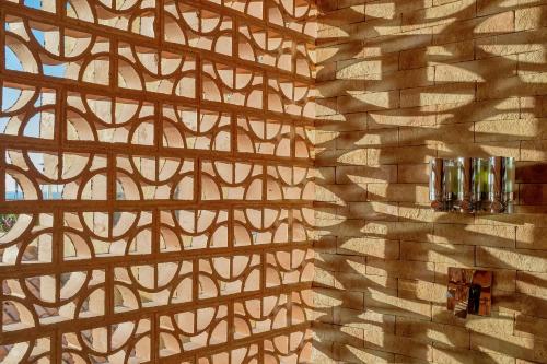 a wall with a patterned wall with two candles on it at Grand Fiesta Americana Los Cabos All Inclusive Golf & Spa in Cabo San Lucas
