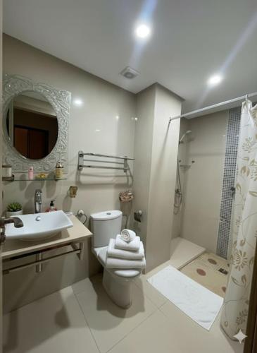 a bathroom with a toilet and a sink and a shower at Beachside Charming Apartment in Tamaris