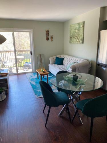 a living room with a glass table and a couch at Peterborough Cosy Apartment in Peterborough