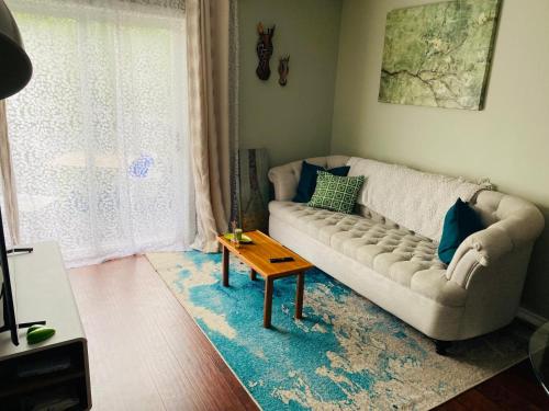 a living room with a couch and a table at Peterborough Cosy Apartment in Peterborough