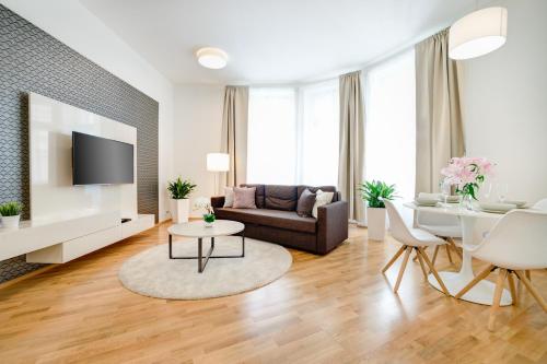 a living room with a couch and a table at Bishop Apartments in Brno