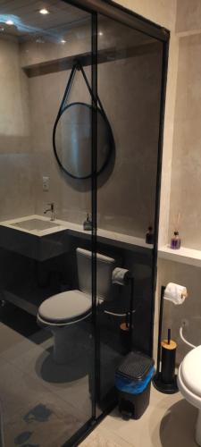 a bathroom with a toilet and a tub and a sink at Apartamento Central in Ametista do Sul