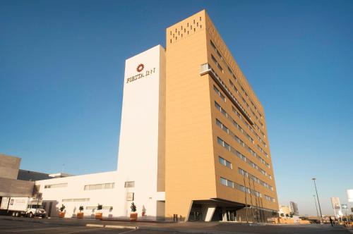 a building with a sign on the side of it at Fiesta Inn Torreon Galerias in Torreón