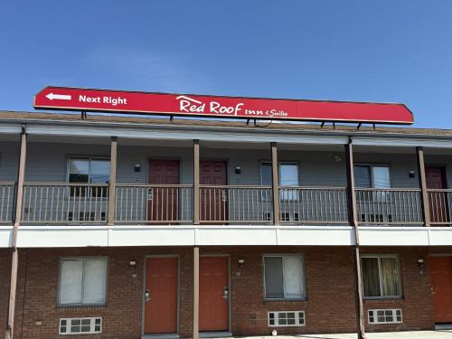 a red roofed red roofed building with red doors at Red Roof Inn & Suites Swansea in Swansea