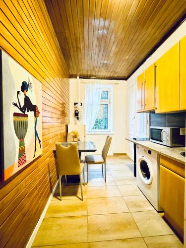 a kitchen with a table and a dining room at Sweet Studio for 3P, 10 Min to FAC Platz in Vienna