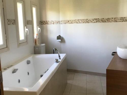 a white bathroom with a tub and a sink at Appartement spacieux à Pra-Loup, terrasse sud, 10 pers - FR-1-165A-202 in Pra-Loup