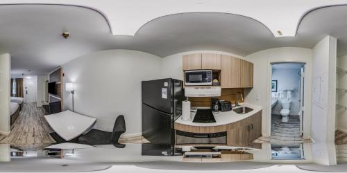 a rendering of a kitchen with a refrigerator at MainStay Suites Knoxville - Cedar Bluff in Knoxville