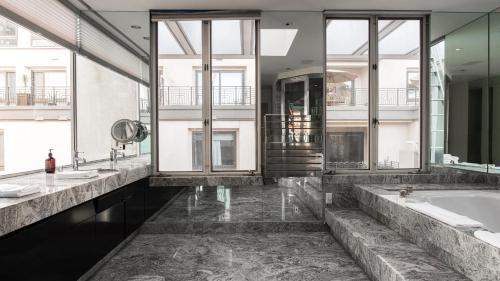 a bathroom with two sinks and a bath tub at Balboa Buyout by AvantStay - Condo w Views in DT San Diego in San Diego
