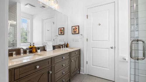 a bathroom with a sink and a mirror at 1 Block to Beach Newly Renovated 6BDR w Rooftop Views Sand Dune by AvantStay in Mount Pleasant