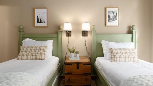 two beds sitting next to each other in a bedroom at Atkinson by AvantStay Lake Front Home w Stunning Views in Tahoe Vista in Tahoe Vista