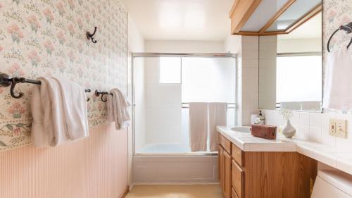a bathroom with a shower and a sink and a tub at Sunnyside by AvantStay Charming Lake Tahoe Chalet on Tahoes West Shore in Tahoe City