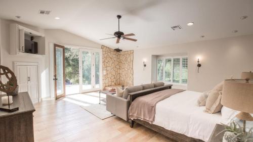 a bedroom with a bed and a ceiling fan at De Luz by AvantStay 5 Acre Estate w Lake Pool Hot Tub in Murrieta