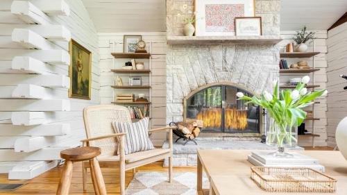 a living room with a fireplace and a table and chairs at Half Moon by AvantStay 4BR Cabin w Large Deck Yard w Patio Outdoor Dining in Great Barrington